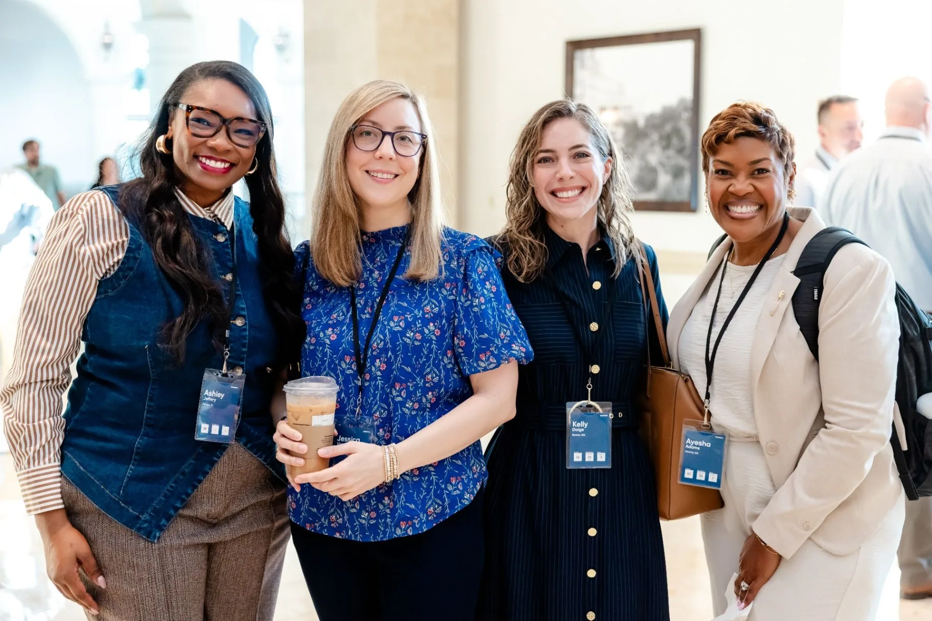 Four conference attendees posing together at a corporate event